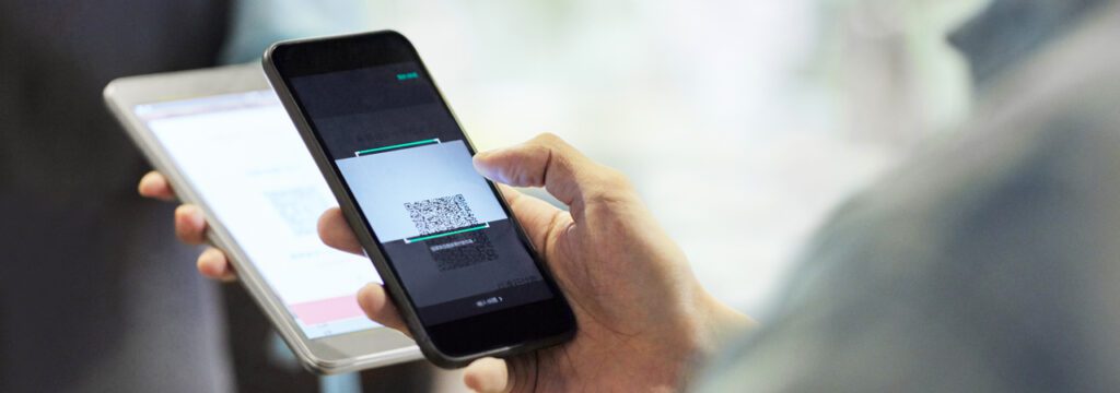 A restaurant customer using mobile ePOS phone payment showcasing B2B IT services for hospitality sector growth