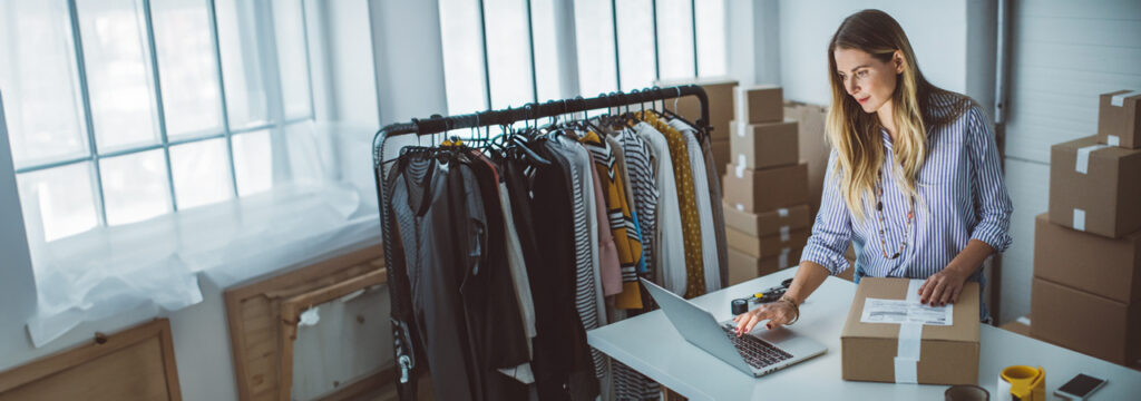 A charity worker using her laptop to stock take inventory at a nonprofit organisation illustrating how Microsoft Copilot transforms nonprofit challenges