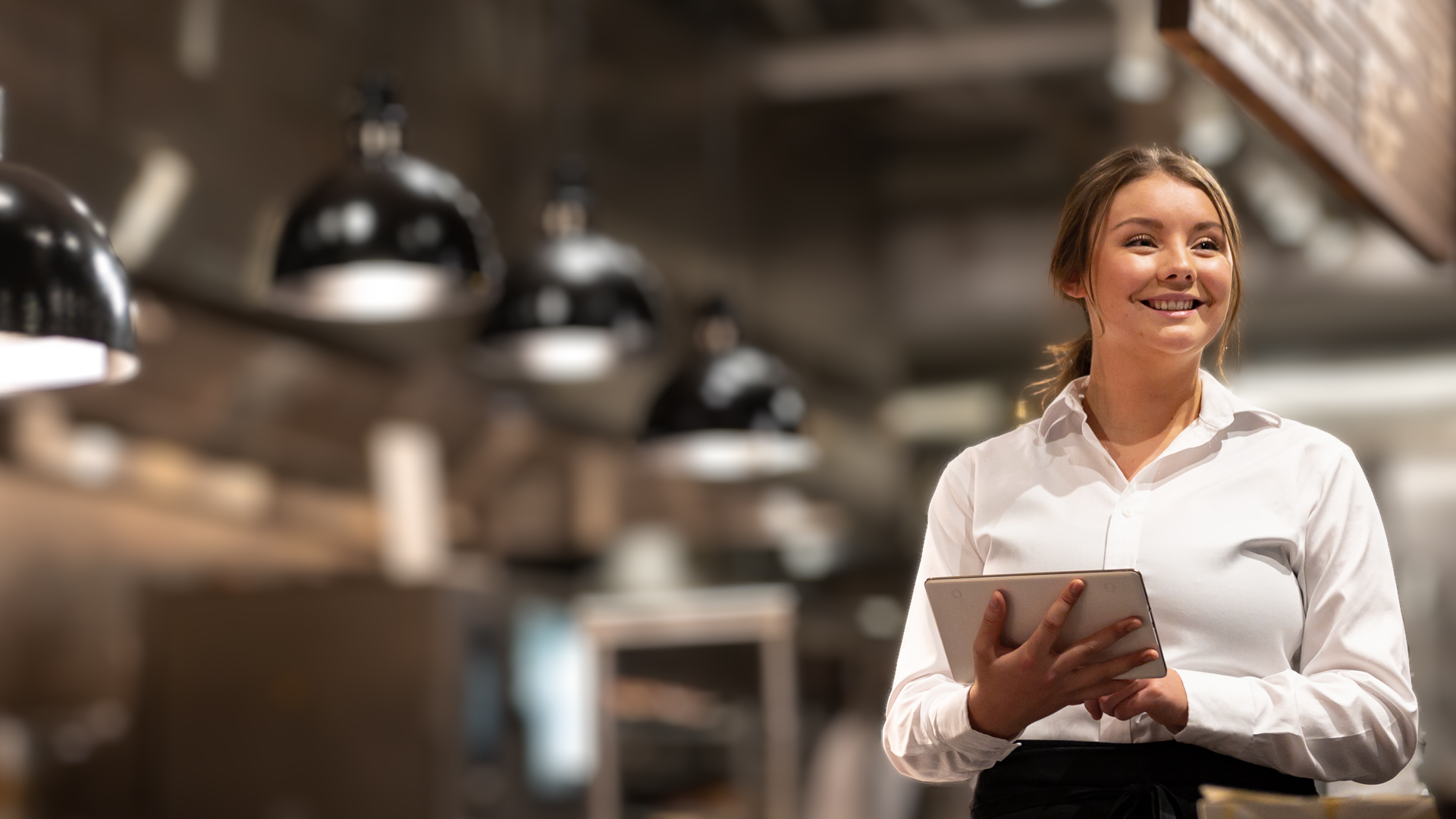 A chef in a kitchen environment using B2B IT services for hospitality sector growth