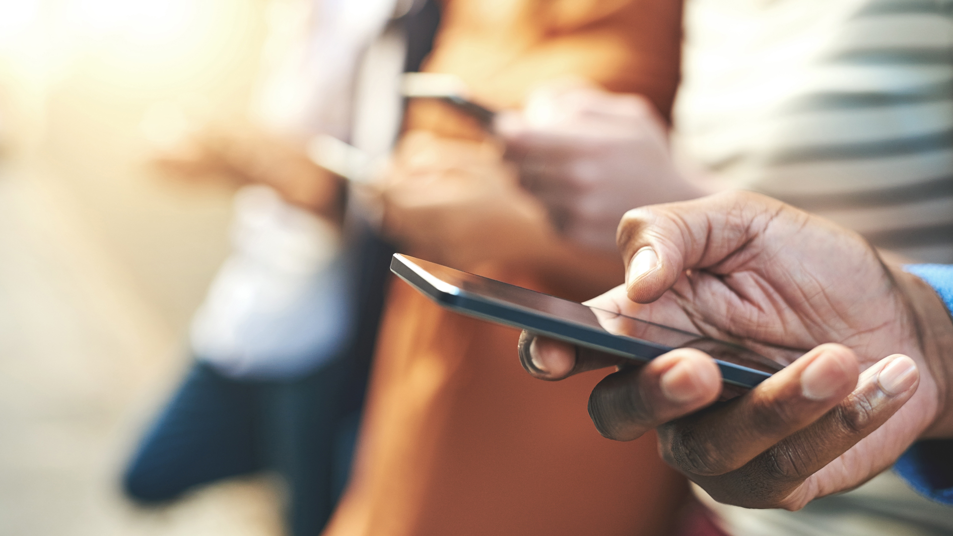 Closeup shot of someone using a mobile device to find out more from the ultimate guide to strong passwords with Cybersecurity 101