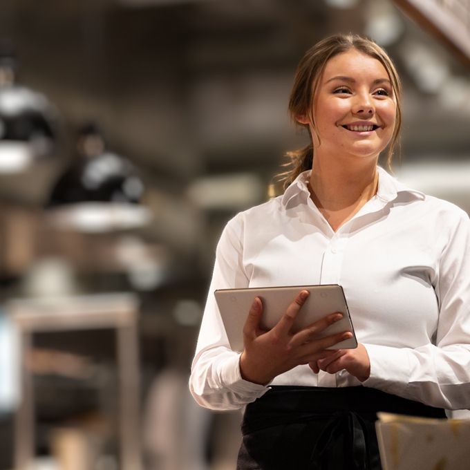 A chef in a kitchen environment using B2B IT services for hospitality sector growth